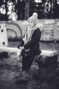 Little cute girl sitting on the bench in winter time Royalty Free Stock Photo