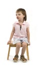 Little cute girl sitting on a chair Royalty Free Stock Photo