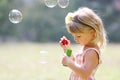 Little cute girl with soap bubbles