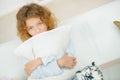 Little cute girl on sofa with pillow Royalty Free Stock Photo