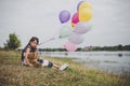 Little cute girl with teddy bear sitting on long green grass out Royalty Free Stock Photo