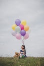 Little cute girl with teddy bear sitting on long green grass out Royalty Free Stock Photo