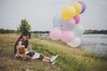 Little cute girl with teddy bear sitting on long green grass out Royalty Free Stock Photo