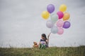 Little cute girl with teddy bear sitting on long green grass out Royalty Free Stock Photo