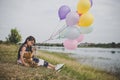 Little cute girl with teddy bear sitting on long green grass out Royalty Free Stock Photo