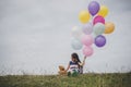 Little cute girl with teddy bear sitting on long green grass out Royalty Free Stock Photo