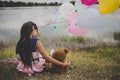 Little cute girl with teddy bear sitting on long green grass out Royalty Free Stock Photo