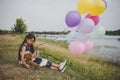 Little cute girl with teddy bear sitting on long green grass out Royalty Free Stock Photo