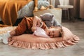 Little cute girl Todler fun plays with pillows in the children`s room