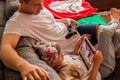 Little cute girl is using tablet, her father is playing console . Royalty Free Stock Photo