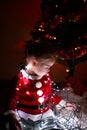 Little cute girl waiting for gifts under the christmas tree Royalty Free Stock Photo