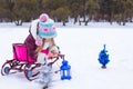 Little cute girl warms her hands on candle in blue Royalty Free Stock Photo