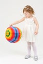 Little cute girl in white dress plays with Royalty Free Stock Photo