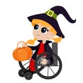 Little cute girl in a witch costume sits on a wheelchair. The child holds in his hands a pumpkin basket for sweets.