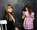 little cute girl with young teacher in classroom studying at bla Royalty Free Stock Photo