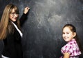 little cute girl with young teacher in classroom studying at bla Royalty Free Stock Photo