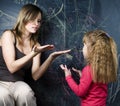 little cute girl with young teacher in classroom studying at bla Royalty Free Stock Photo