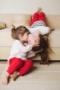 Little cute girls on the couch upside down Royalty Free Stock Photo