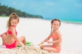 Little cute girls playing with beach toys during tropical vacation Royalty Free Stock Photo