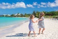 Little cute girls walking along the white beach Royalty Free Stock Photo