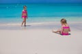 Little cute girls walking along the white beach Royalty Free Stock Photo