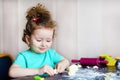 Little cute happy girl making bakery, preparing homemade cookies, muffins, cake for the holiday