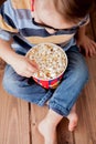 Little cute kid baby boy 2-3 years old , 3d imax cinema glasses holding bucket for popcorn, eating fast food on wooden background Royalty Free Stock Photo