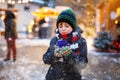 Little cute kid boy drinking hot children punch or chocolate on German Christmas market. Happy child on traditional Royalty Free Stock Photo