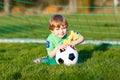 Little cute kid boy of 4 playing soccer with football on field, outdoors Royalty Free Stock Photo