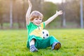 Little cute kid boy of 4 playing soccer with football on field, outdoors Royalty Free Stock Photo