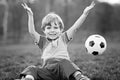 Little cute kid boy of 4 playing soccer with football on field, outdoors Royalty Free Stock Photo