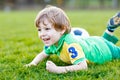 Little cute kid boy of 4 playing soccer with football on field, outdoors Royalty Free Stock Photo