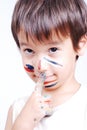 Little cute kid with colors on his face Royalty Free Stock Photo