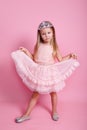 Little cute kid girl birthday princess 5-6 years old wears pink dress crown diadem posing on pink background Royalty Free Stock Photo
