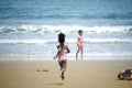 Little cute kid girl  having fun on sandy summer with blue sea, happy childhood friend running and  playing on tropical beach Royalty Free Stock Photo