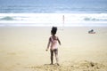 Little cute kid girl  having fun on sandy summer with blue sea, happy childhood girls friend running and  playing on tropical beac Royalty Free Stock Photo