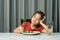 Little cute kid girl refusing to eat healthy vegetables. Children do not like to eat vegetables Royalty Free Stock Photo