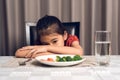 Little cute kid girl refusing to eat healthy vegetables. Children do not like to eat vegetables Royalty Free Stock Photo