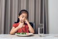 Little cute kid girl refusing to eat healthy vegetables. Children do not like to eat vegetables Royalty Free Stock Photo