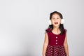 Little cute kid girl 3-4 years old listen music in wireless headphones in studio shot isolated Royalty Free Stock Photo