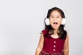 Little cute kid girl 3-4 years old listen music in wireless headphones Royalty Free Stock Photo