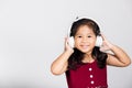 Little cute kid girl 3-4 years old listen music in wireless headphones Royalty Free Stock Photo