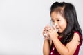 Little cute kid girl 3-4 years old smile drinking fresh water from glass in studio shot isolated Royalty Free Stock Photo