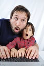A little cute kid with a laptop shocked Royalty Free Stock Photo