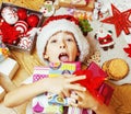 little cute kid in santas red hat with handmade gifts, toys vint Royalty Free Stock Photo