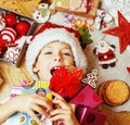 little cute kid in santas red hat with handmade gifts, toys vint Royalty Free Stock Photo