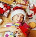 little cute kid in santas red hat with handmade gifts, toys vint Royalty Free Stock Photo