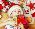 little cute kid in santas red hat with handmade gifts, toys vint Royalty Free Stock Photo