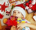 little cute kid in santas red hat with handmade gifts, toys vint Royalty Free Stock Photo