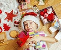 Little cute kid in santas red hat with handmade gifts, toys vintage Royalty Free Stock Photo